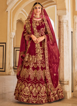 Photo of bride showing off her red velvet bridal lehenga