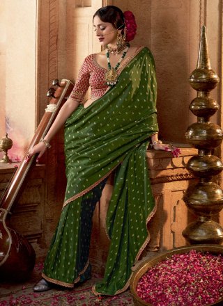 Patch Border, Booti, Lace and Zari Work Pure Crepe Trendy Saree In Green